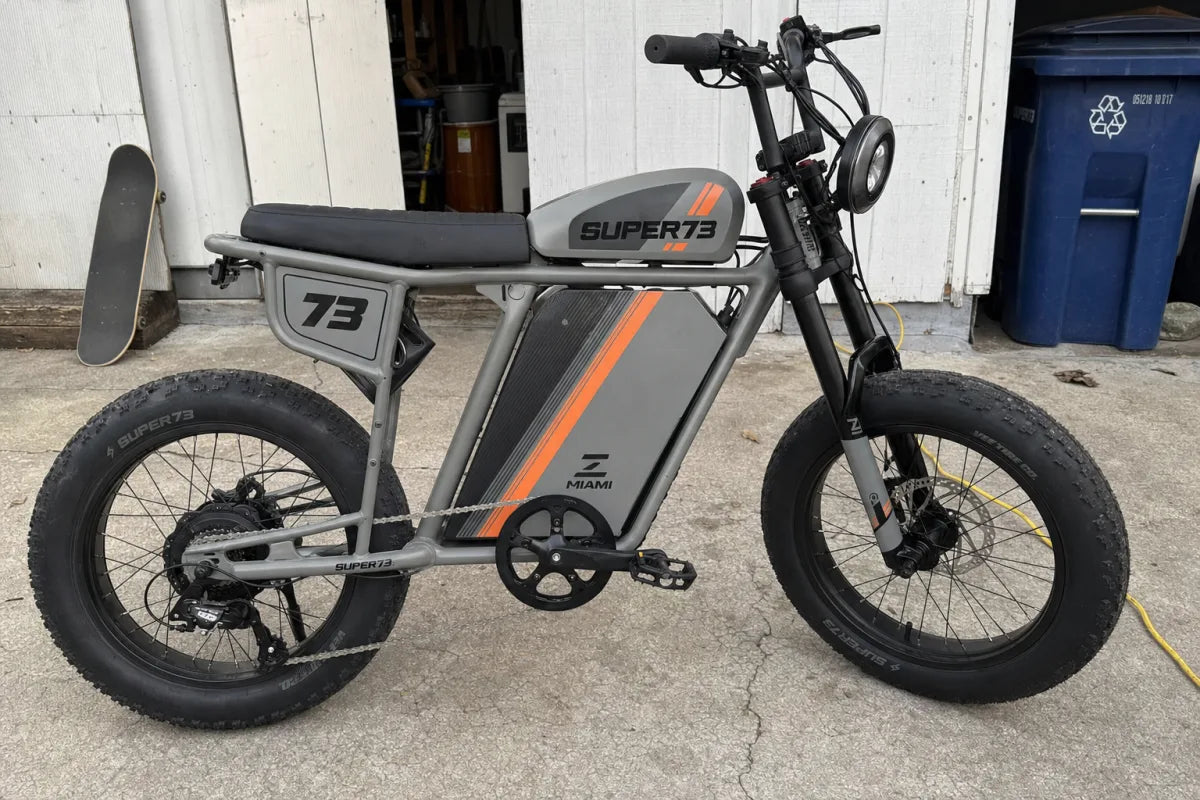 Super73 Z Miami with simple club race graphics by a backyard shed