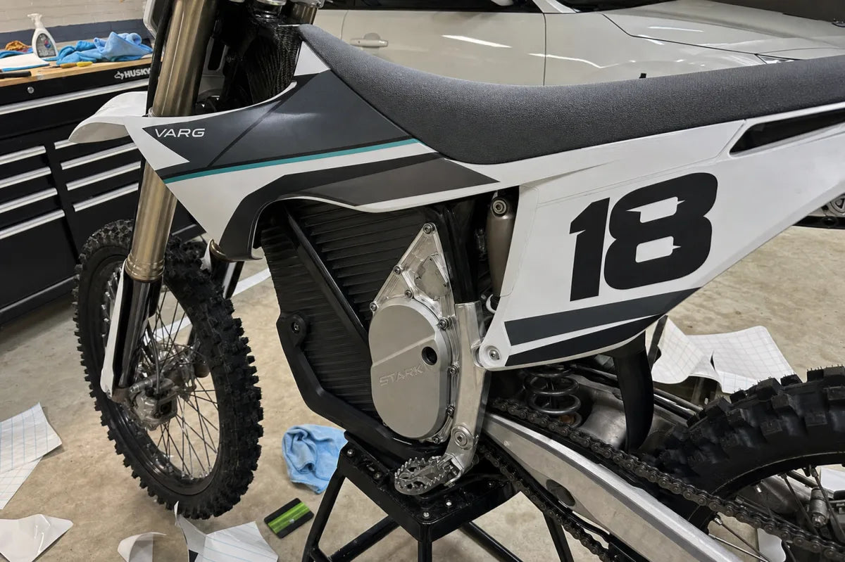 Stark Varg race kit installation close-up in a garage