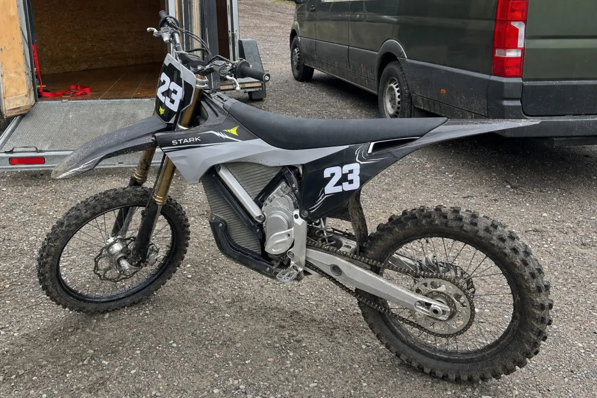 Muddy Stark Varg with OEM-style race graphics beside a trailer